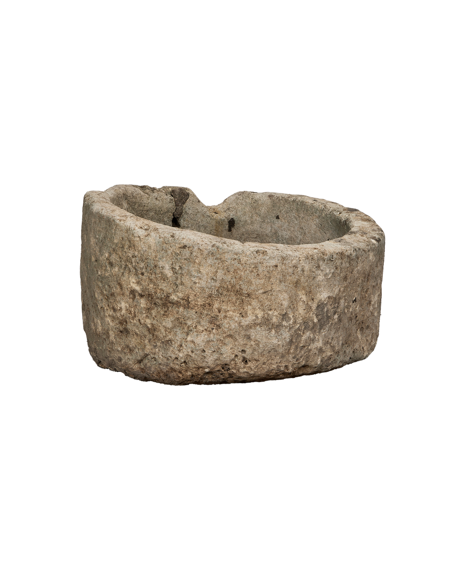 Vintage Indonesian round limestone trough, showing weathered side texture.
