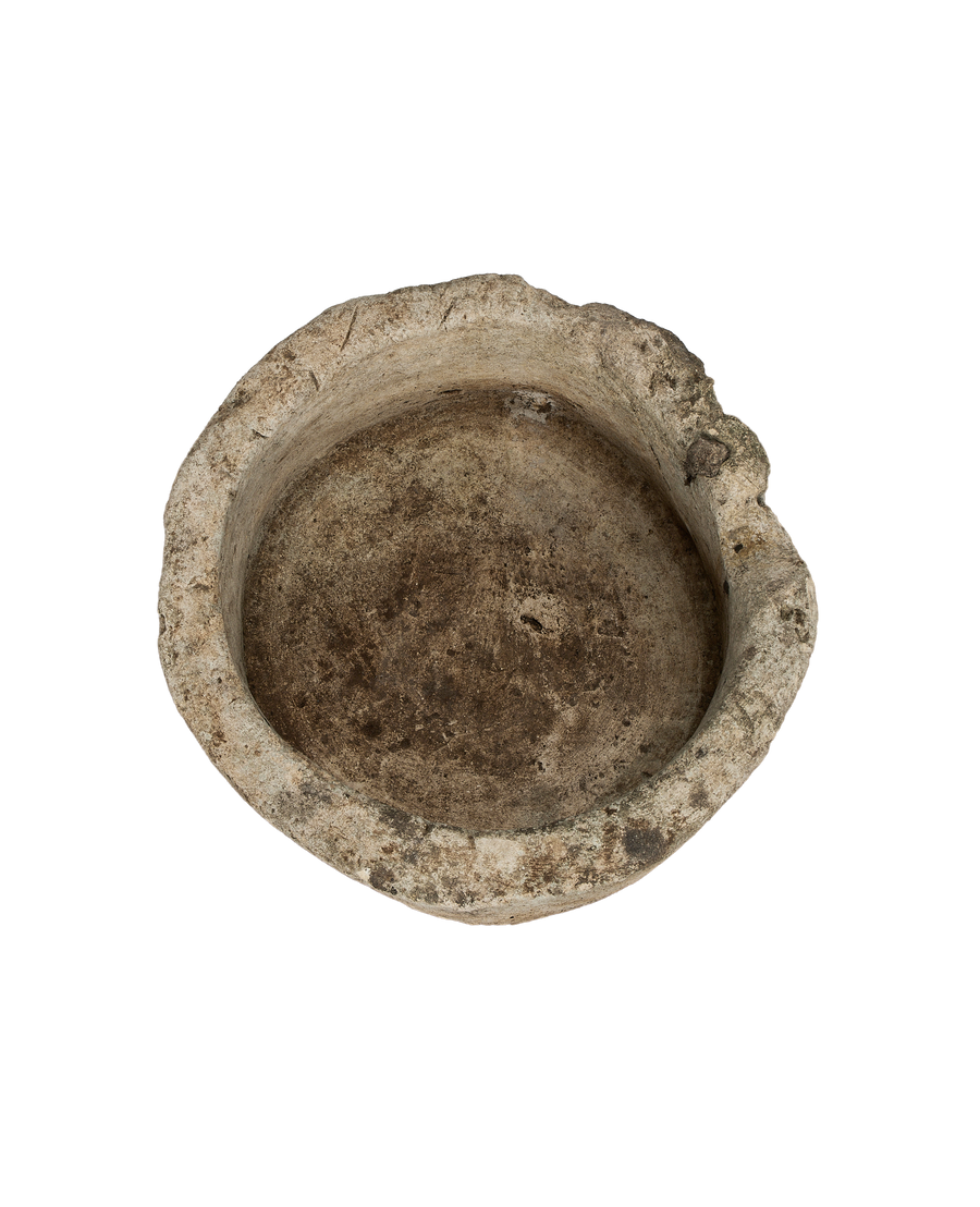 Vintage Indonesian limestone trough, showing the rough, aged textured interior and uneven rim.