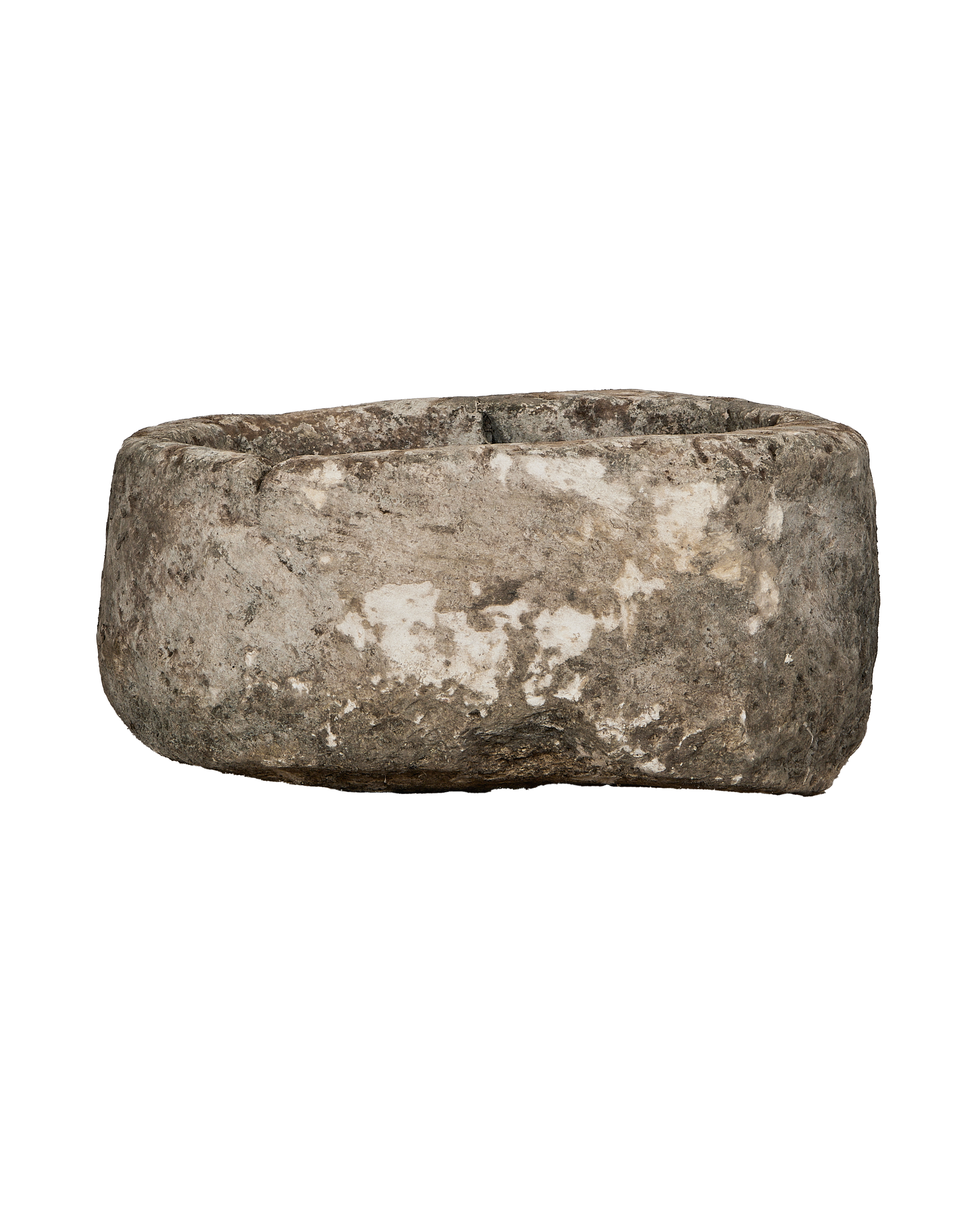 Vintage oblong limestone trough from Indonesia, weathered surface texture visible, side view.