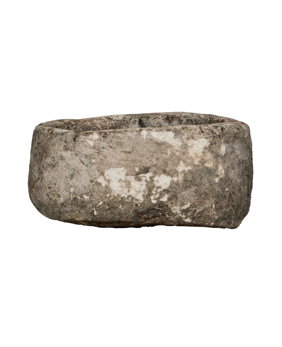 Vintage oblong limestone trough from Indonesia, weathered surface texture visible, side view.