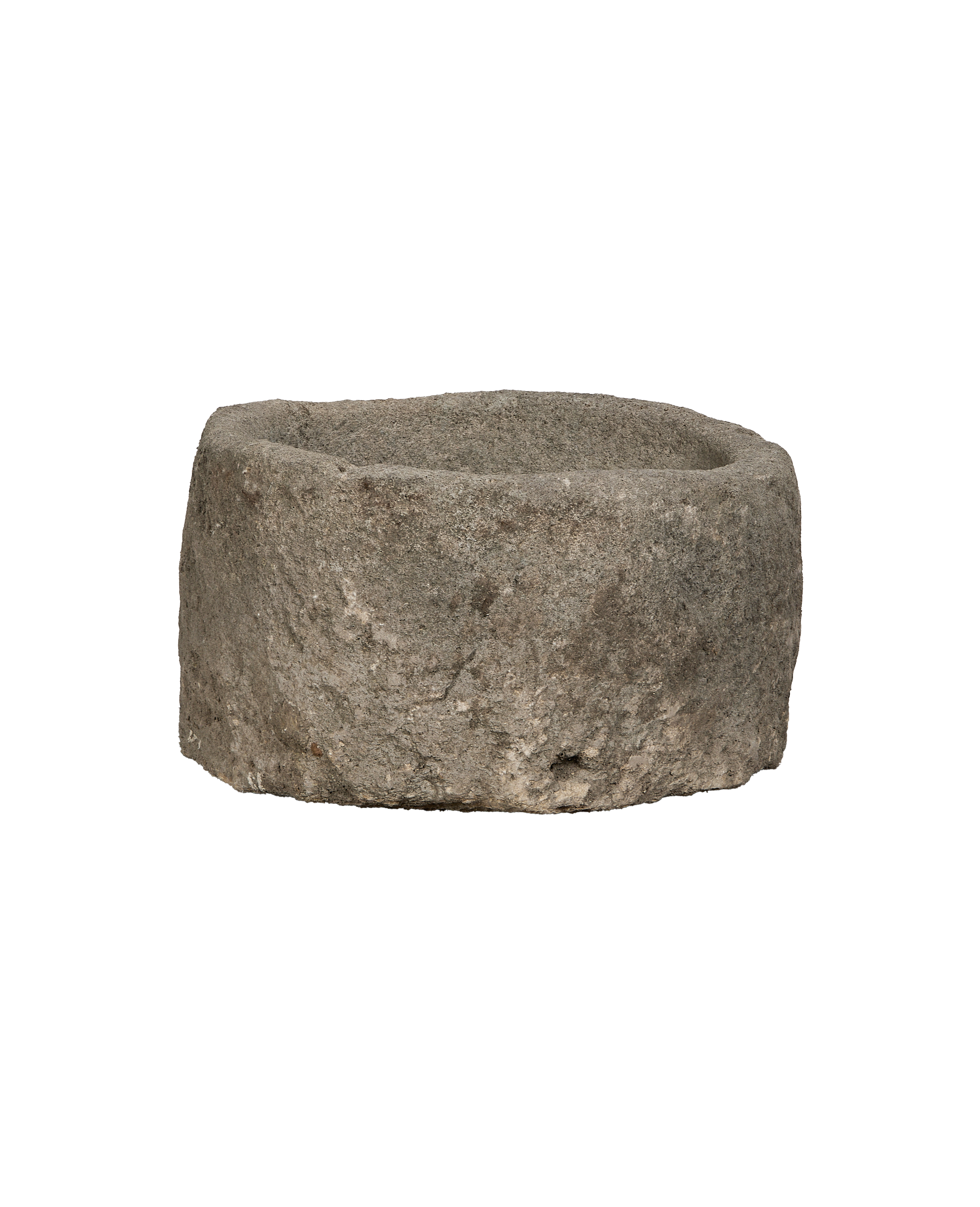 Vintage round Indonesian limestone trough, showing rough weathered exterior texture and thick walls.