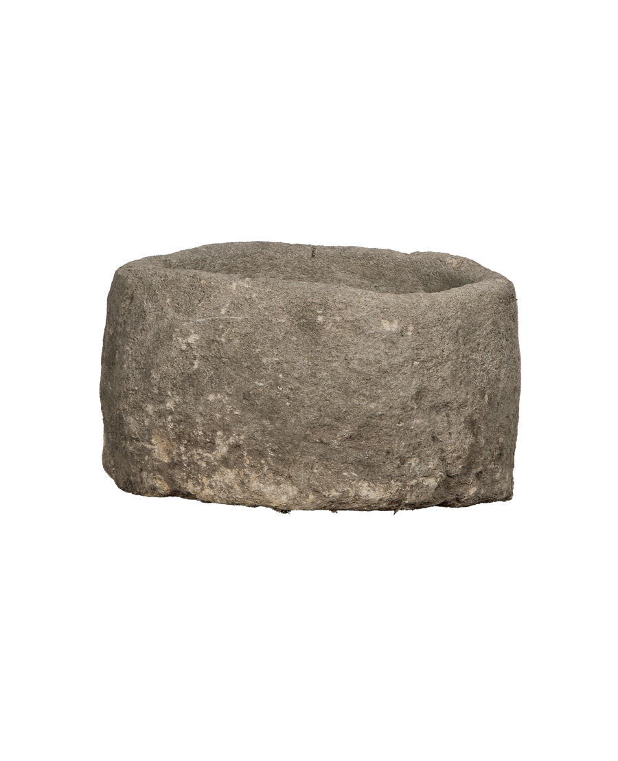 Vintage Indonesian limestone trough, showing the rustic rough texture and rounded shape from top view.