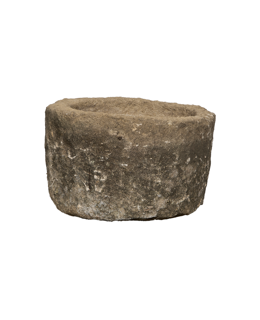 Vintage Indonesian round limestone trough, aged texture, with minor chipping details.
