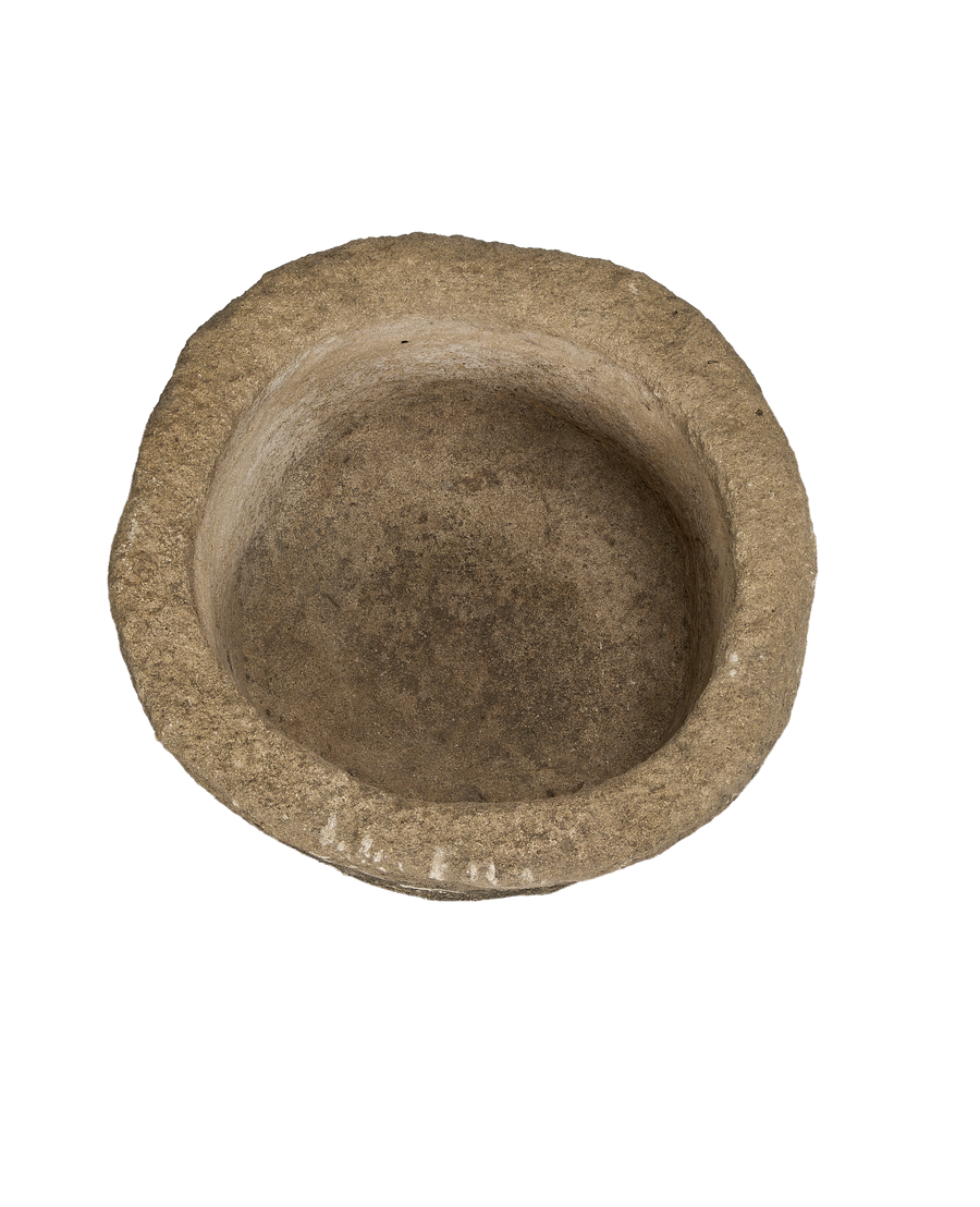 Round vintage Indonesian limestone trough with textured surface and worn interior from above.