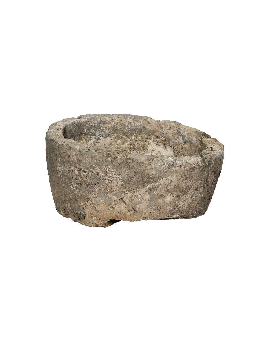 Vintage Indonesian limestone trough showcasing weathered texture and unique organic shape.