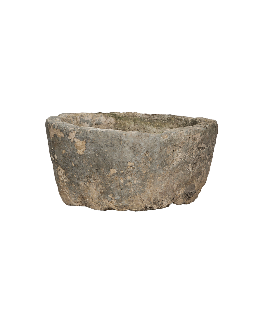 Vintage round limestone trough, full low-angle view showing weathered surface texture from Indonesia.