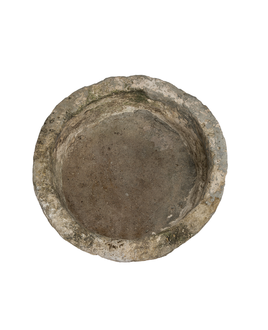Vintage round limestone trough, showing weathered texture and interior basin, from Indonesia.