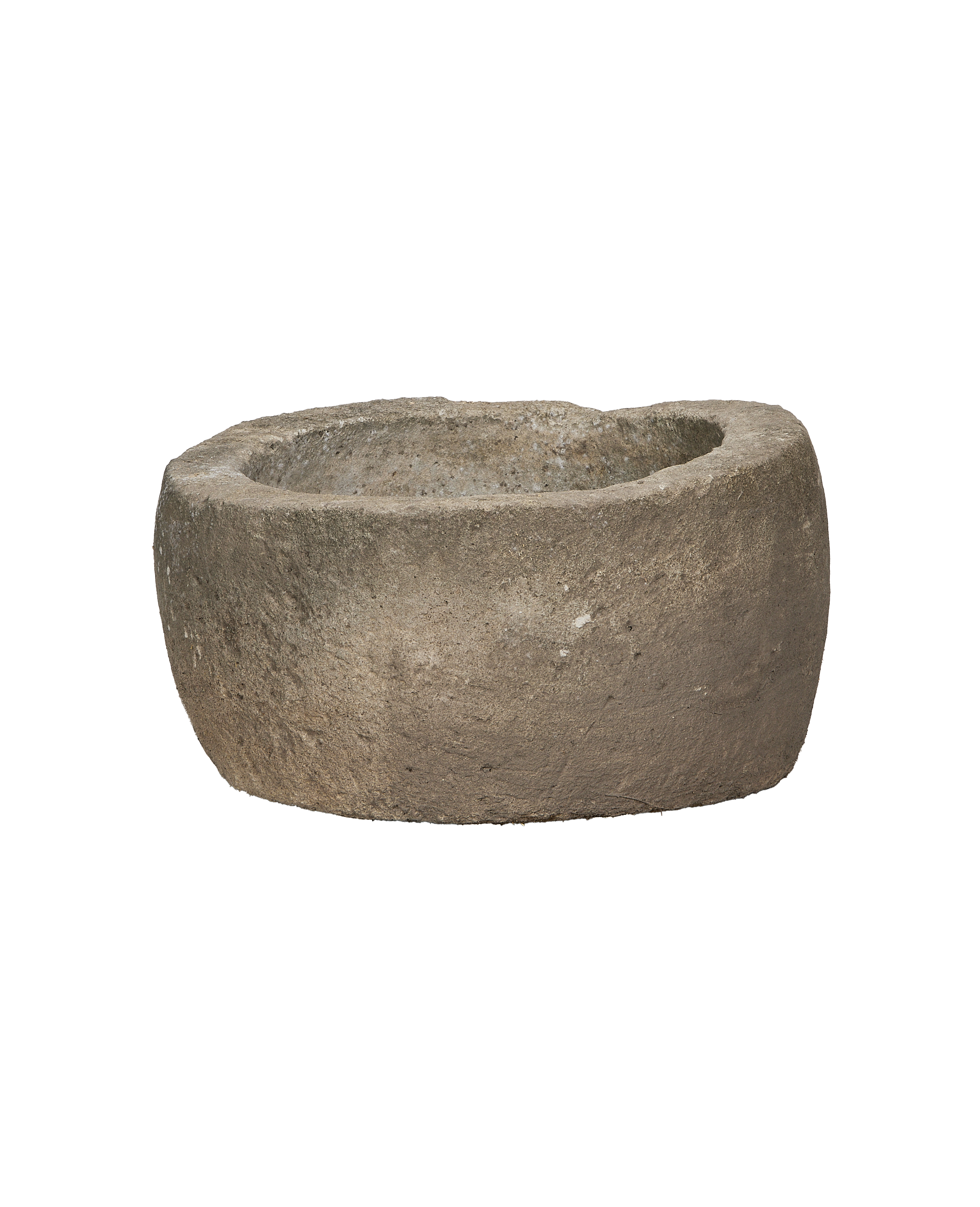 Vintage Indonesian limestone trough, showing rough textured exterior and gently sloped interior.