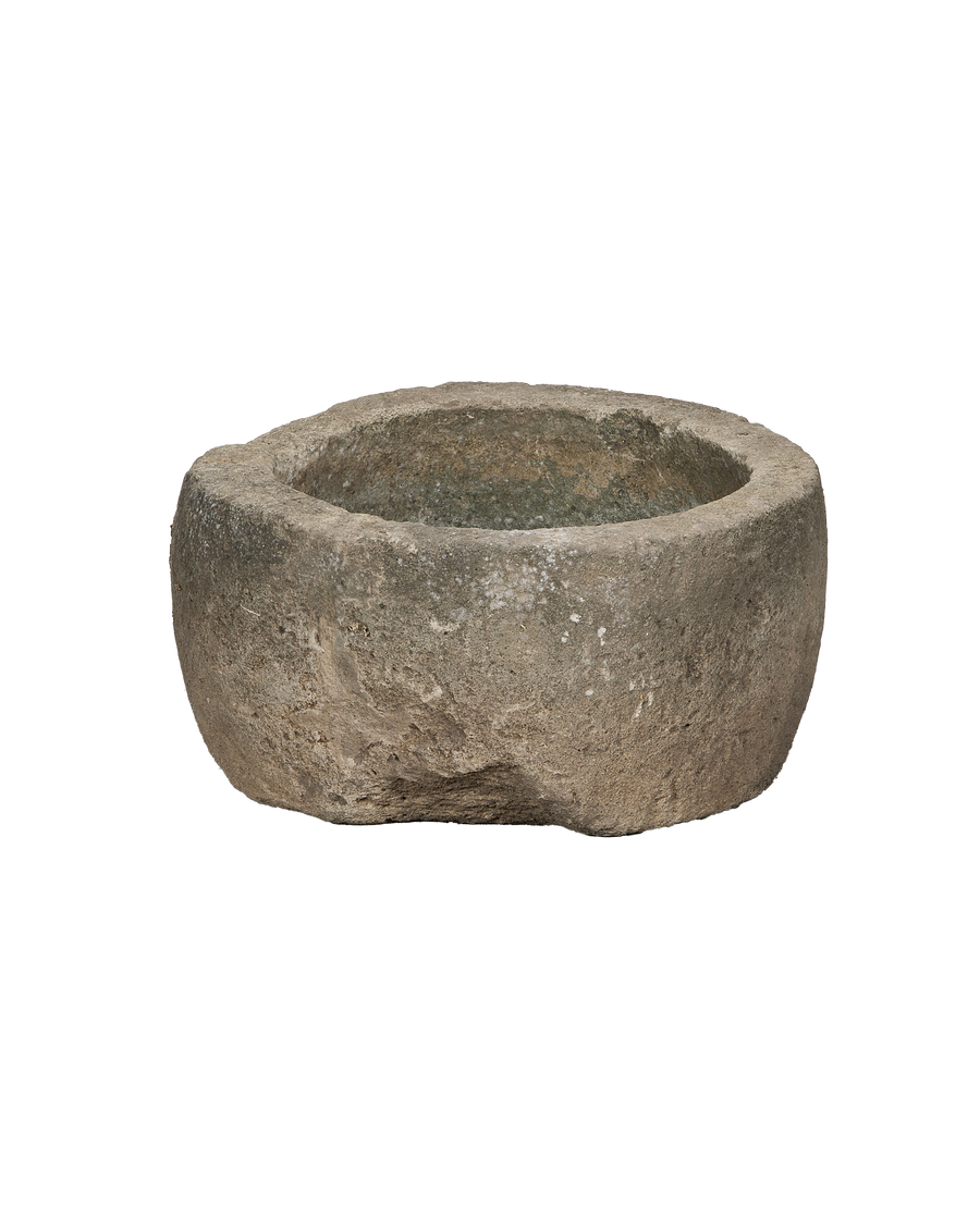 Vintage round limestone trough, aged grey patina, Indonesia origin, shown from a side angle.