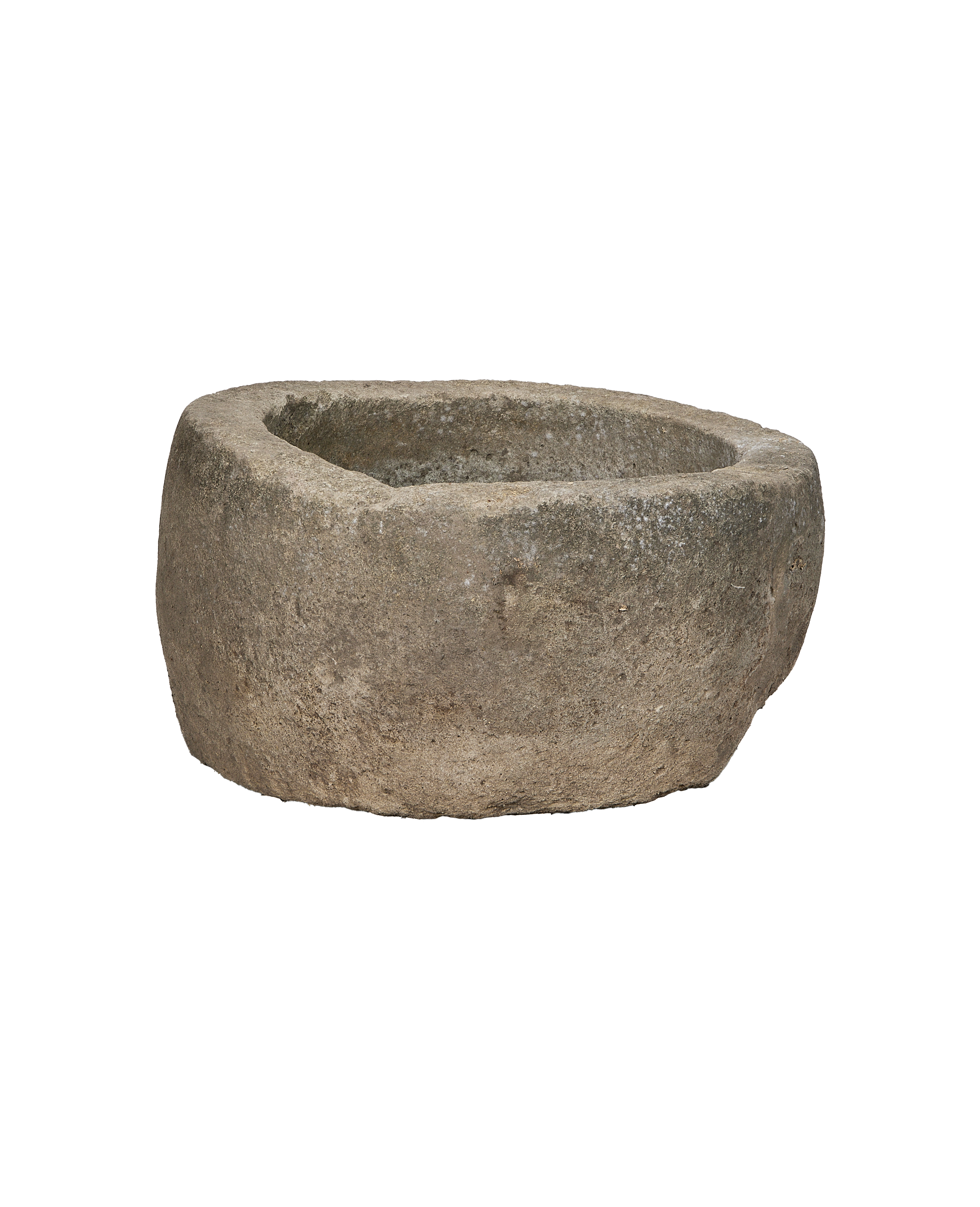 Vintage Indonesian round limestone trough, close-up of rough textured surface and weathered rim.