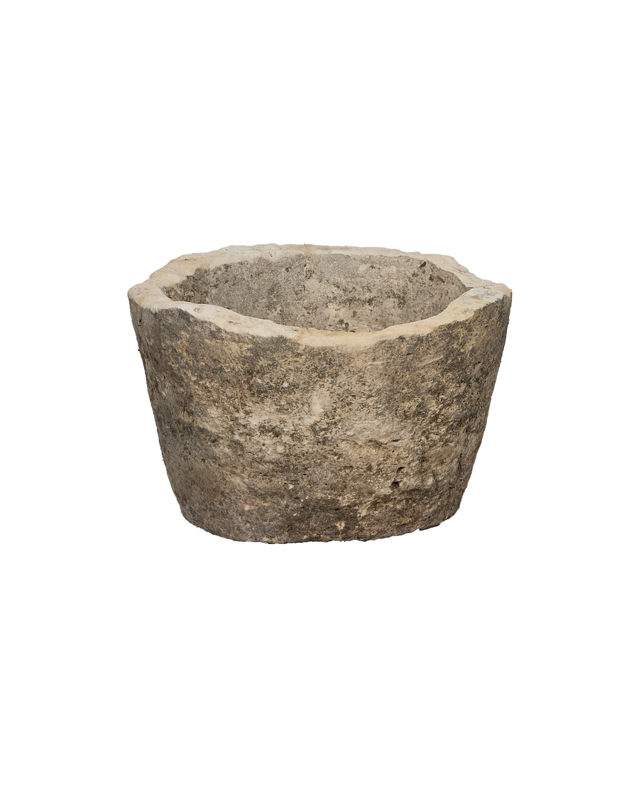 Vintage round limestone trough, top opening showing texture and aged condition.
