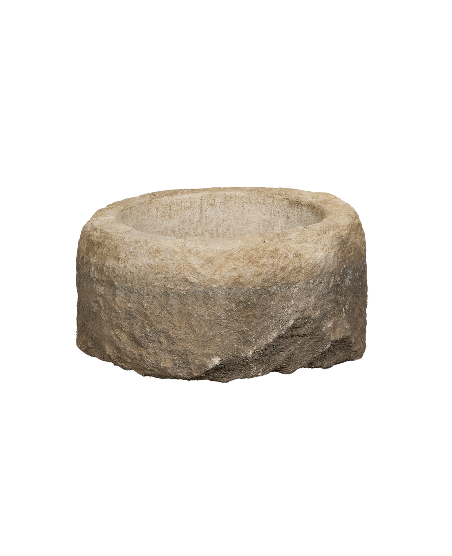 Vintage limestone trough from Indonesia, showing rough exterior texture and round interior.