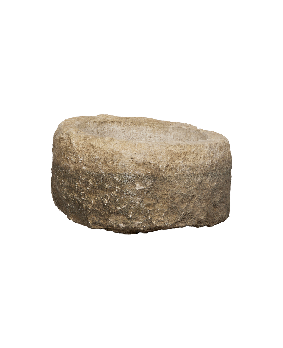 Vintage round limestone trough, aged texture, with deep basin and rough sides.