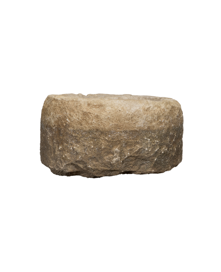 Vintage Indonesian round limestone trough, rich textured side view, weathered condition.
