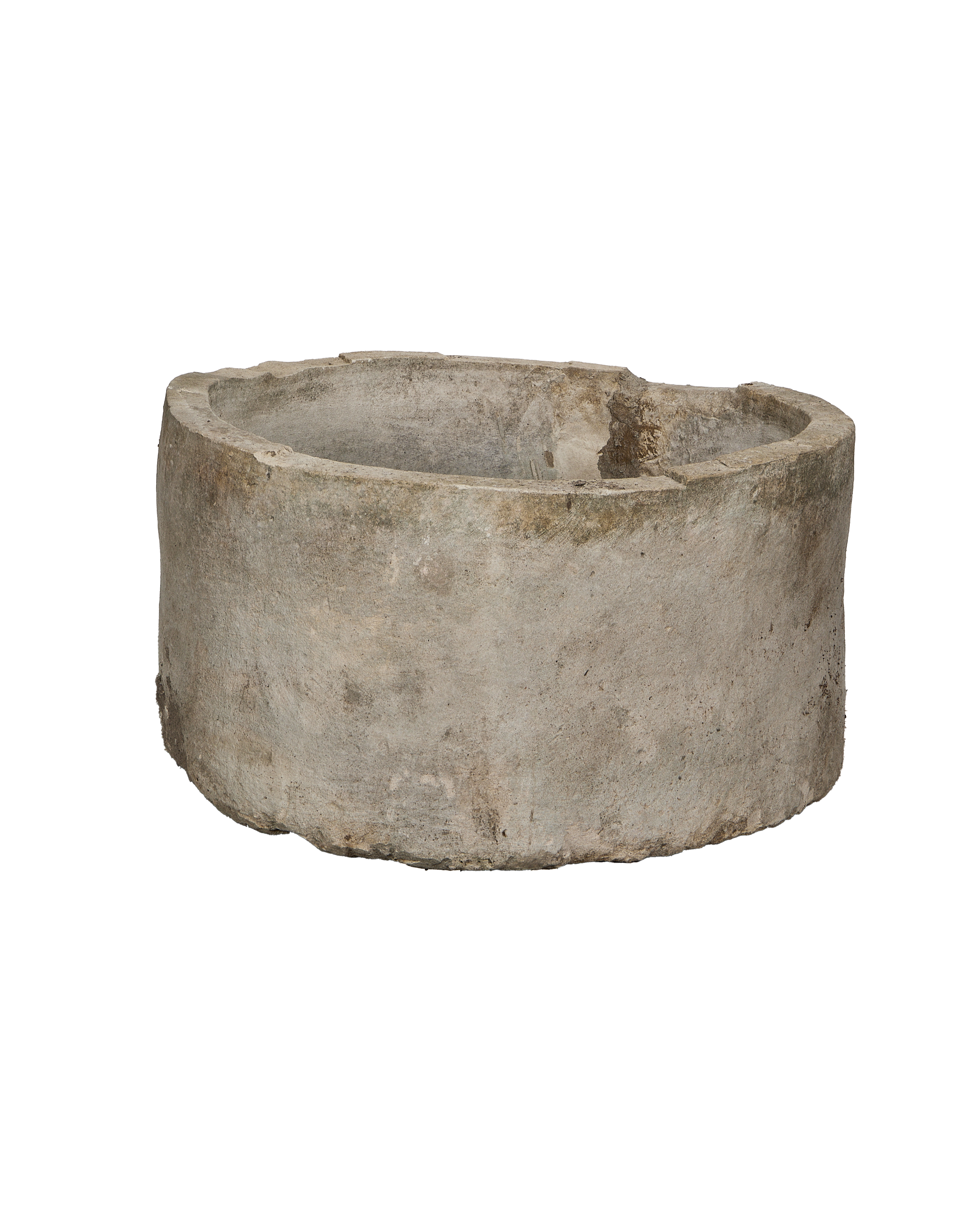 Vintage Indonesian round limestone trough, showing a complete side profile with subtle pitting and rough texture.