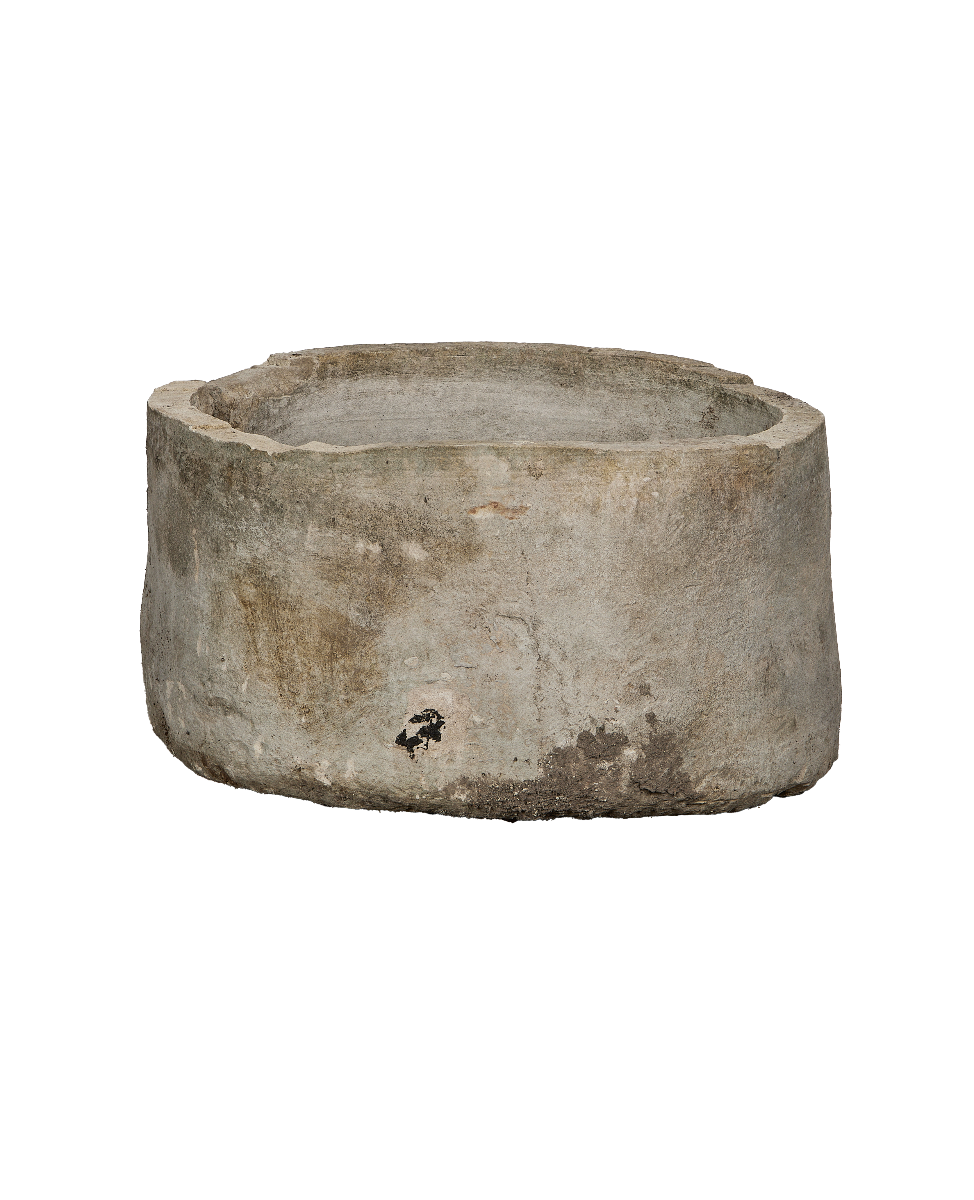 Vintage round Indonesian limestone trough, showing a rugged, weathered exterior with natural patina.