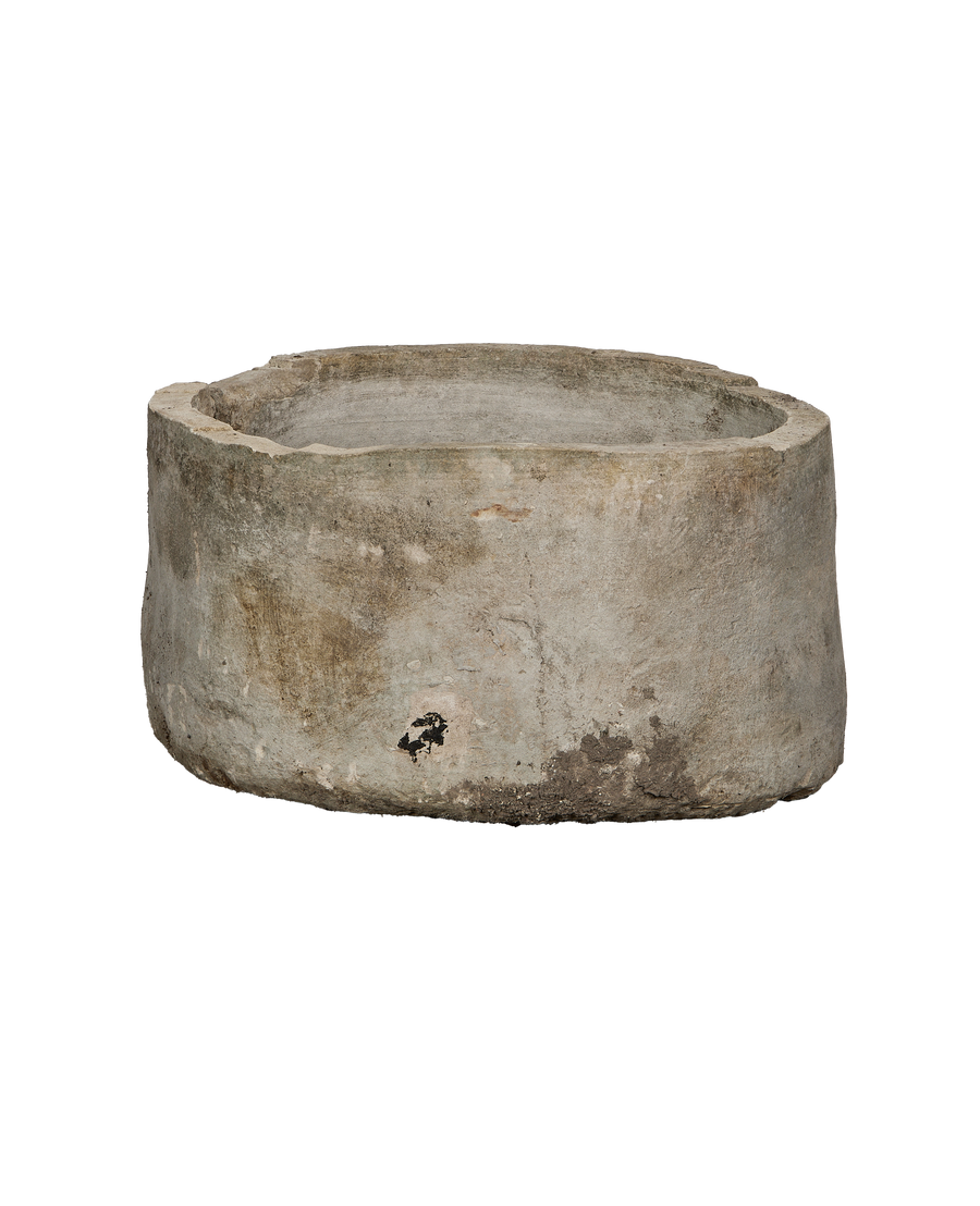 Vintage round Indonesian limestone trough, showing a rugged, weathered exterior with natural patina.
