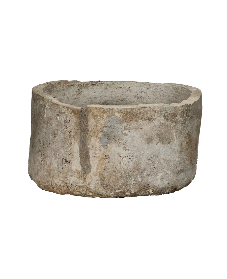Vintage round Indonesian limestone trough, detailed view of textured weathered surface.