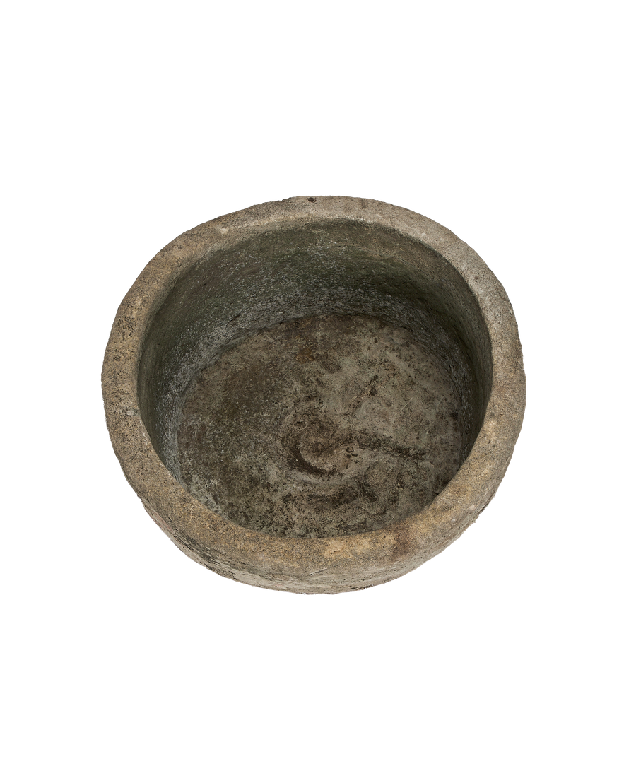 Vintage round limestone trough, aged texture, showing interior basin and eroded rim from above.