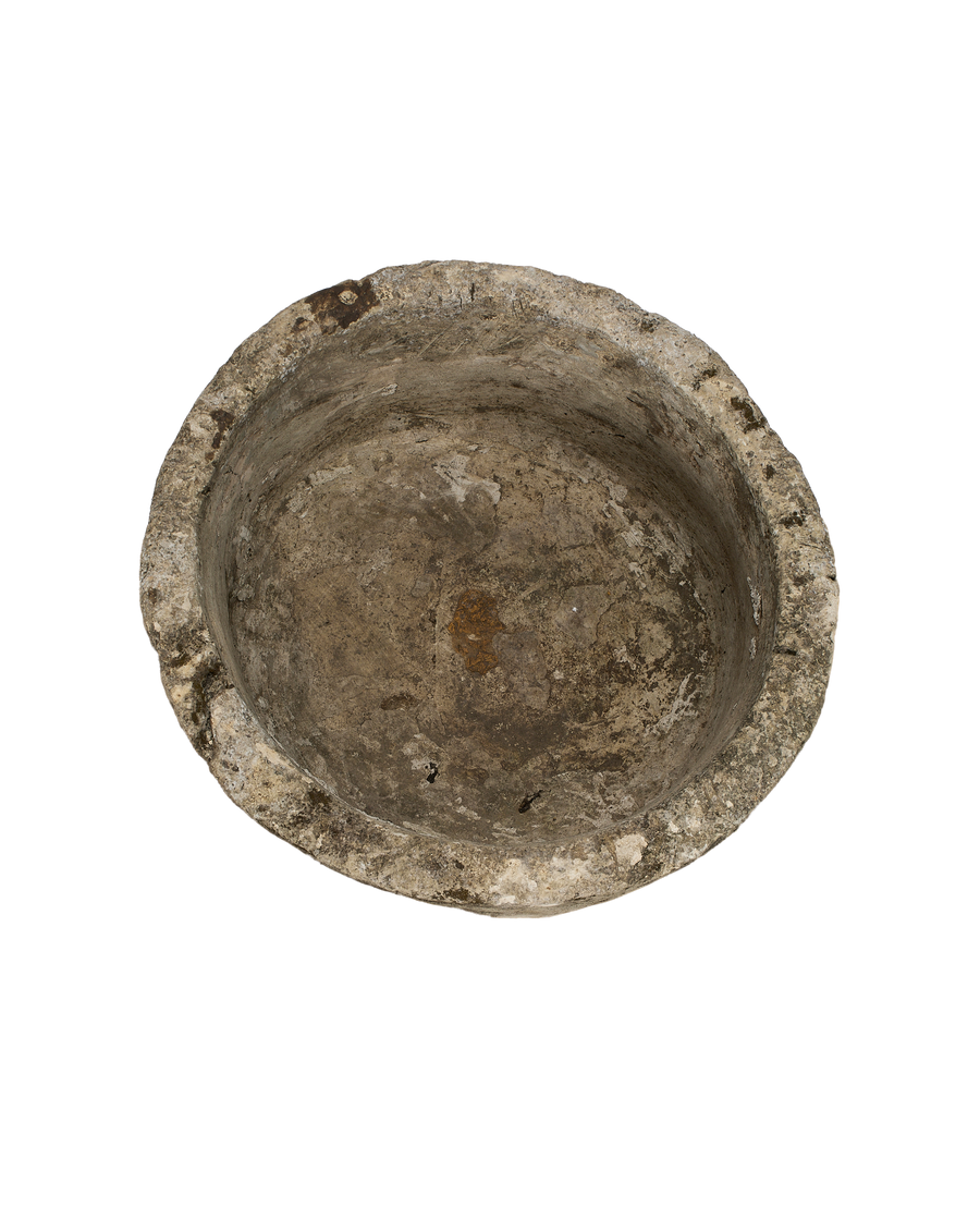 Vintage Indonesian round limestone trough, top-down view showing interior's weathered texture and moss remnants.