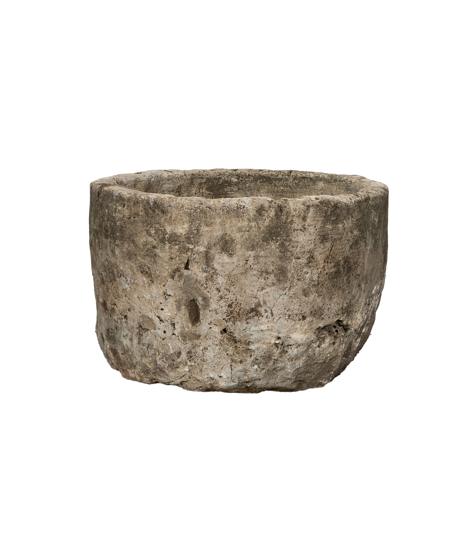 Vintage Indonesian round limestone trough, showing surface texture, cracks, and weathered patina.