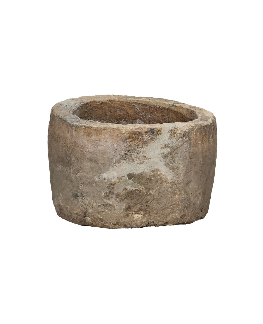 Vintage round limestone trough, showing its aged rustic surface and Indonesian origins.