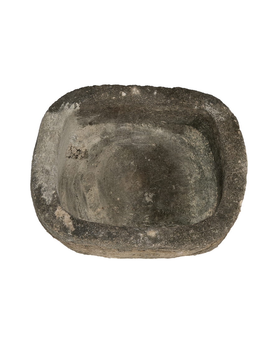 Vintage Indonesian limestone trough closeup, showcasing aged, weathered surface and organic oblong shape.