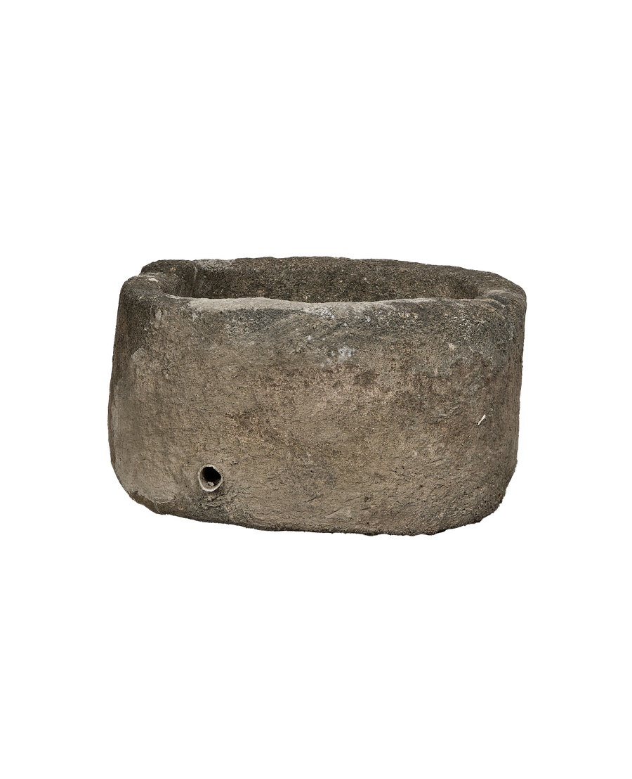 Vintage oblong limestone trough, weathered gray texture, with a drilled drainage hole.