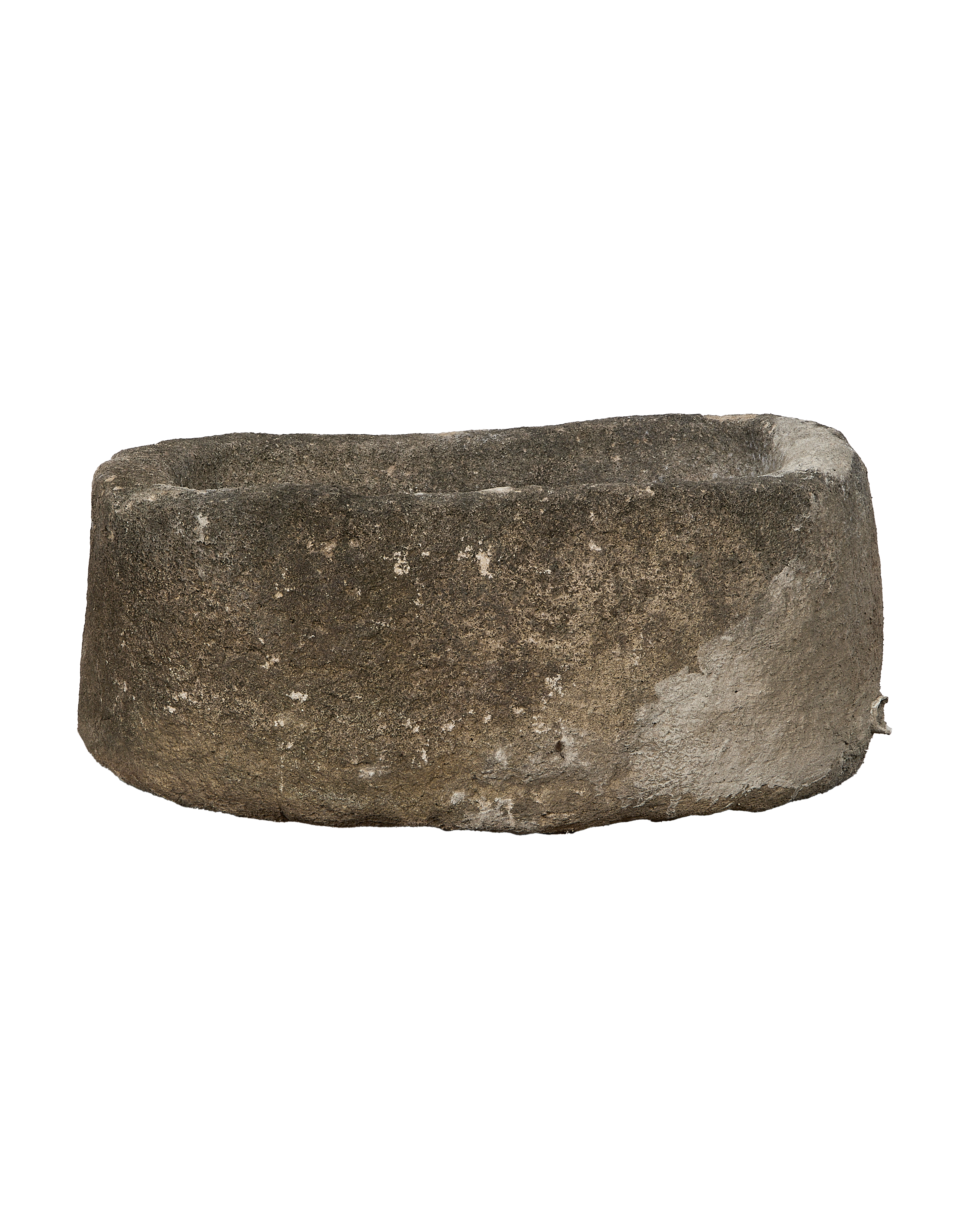 Vintage Indonesian oblong limestone trough, showing a side angle with texture details.
