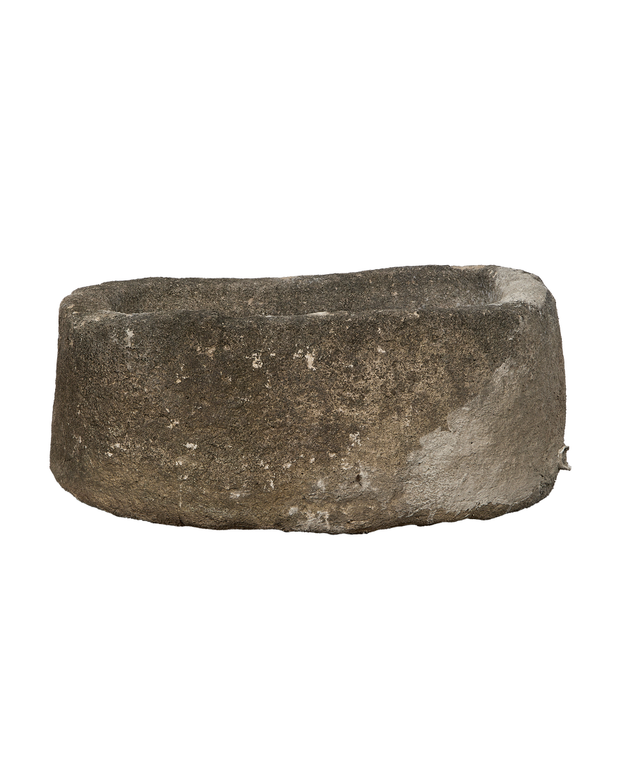 Vintage Indonesian oblong limestone trough, showing a side angle with texture details.