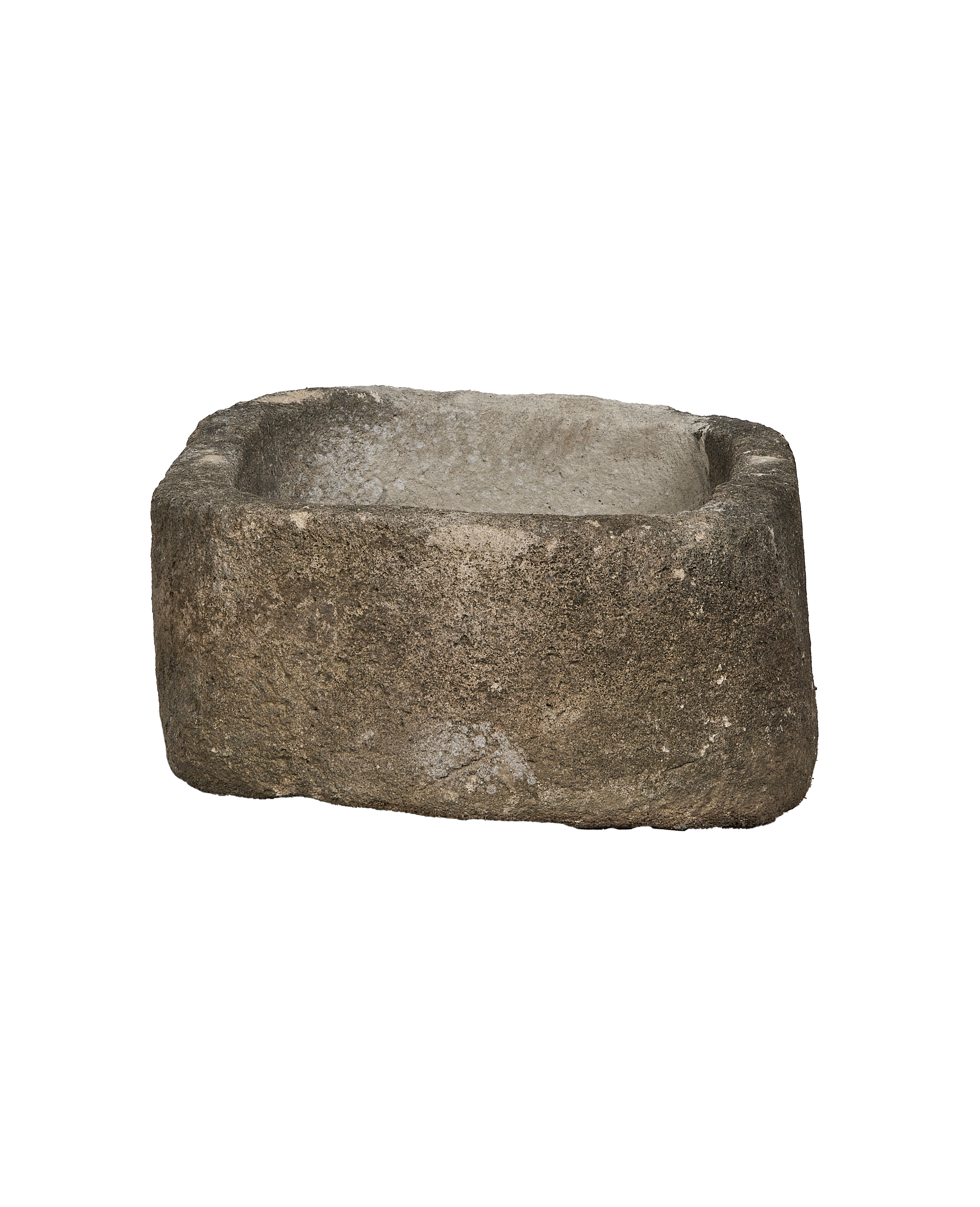 Vintage Indonesian limestone trough viewed from an angle, showing its oblong shape and rustic texture.