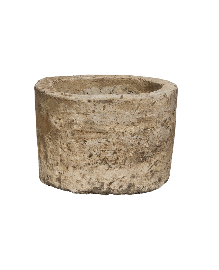 Vintage round Indonesian limestone trough, showing a full, weathered exterior.