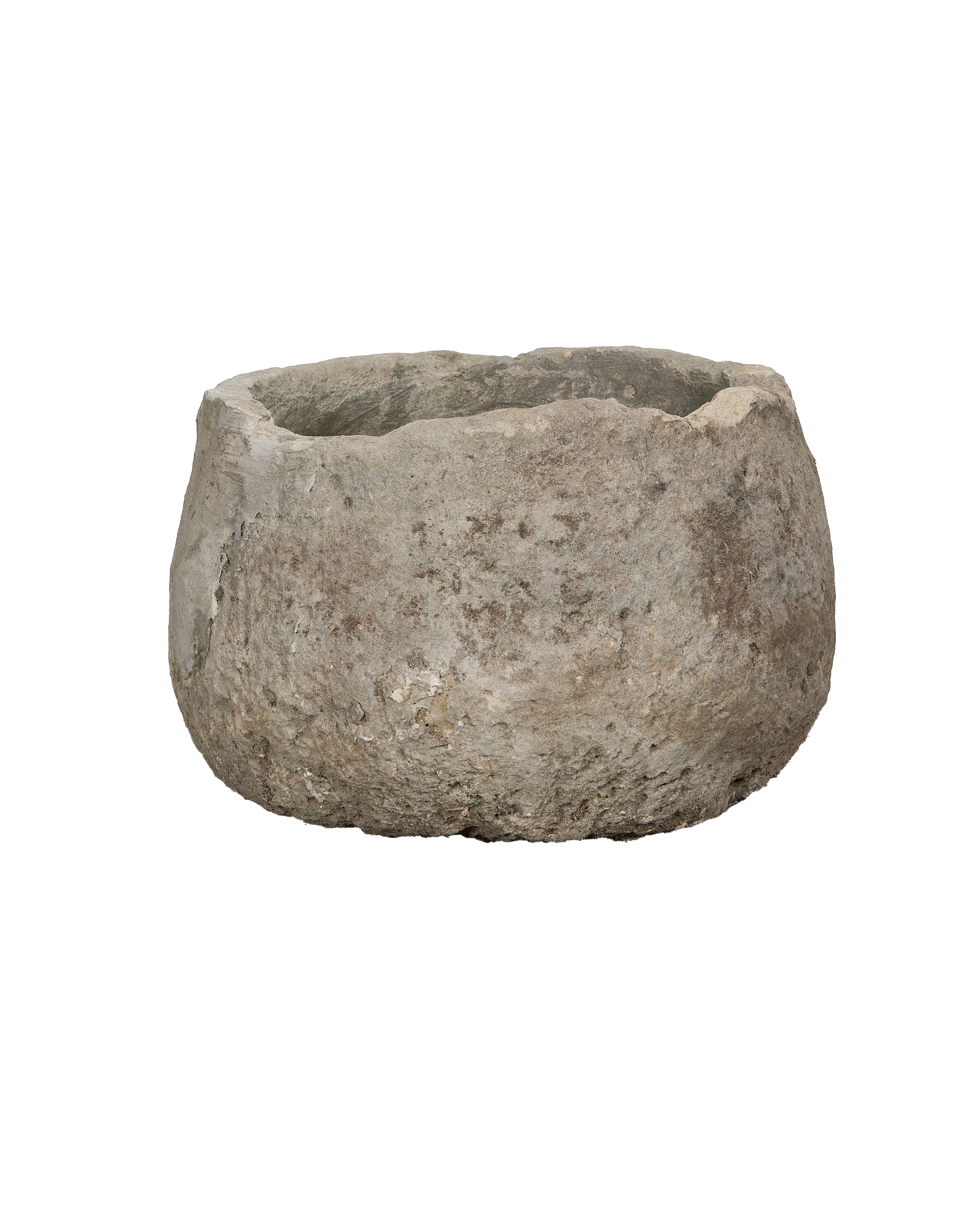 Vintage round limestone trough, close-up texture, showing rough weathered surface detail.