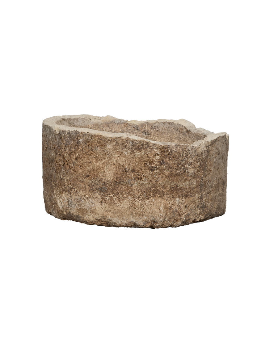 Vintage Indonesian limestone trough, round, showcasing natural rough texture and weathered finish.