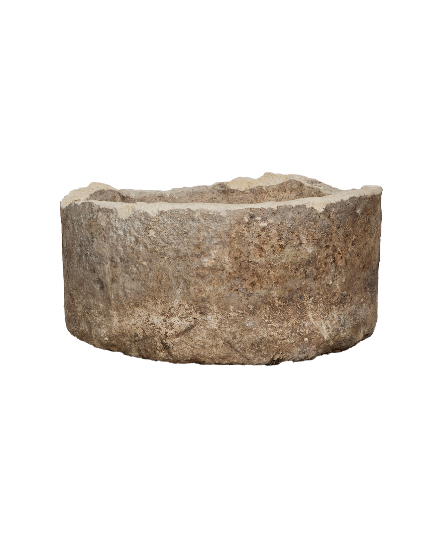Vintage Indonesian limestone trough, round, showing detailed weathered texture and rugged edge.