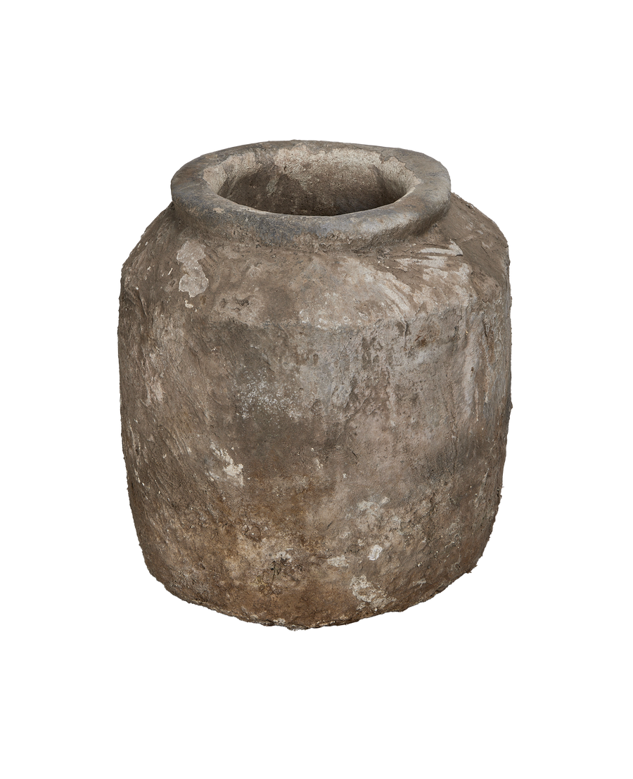 Vintage Indonesian limestone pot's rough, weathered exterior texture and robust rim.
