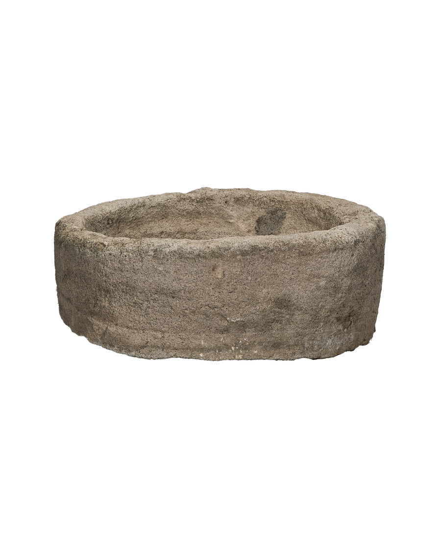 Vintage round limestone trough from Indonesia, showing rough texture and weathered condition detail.