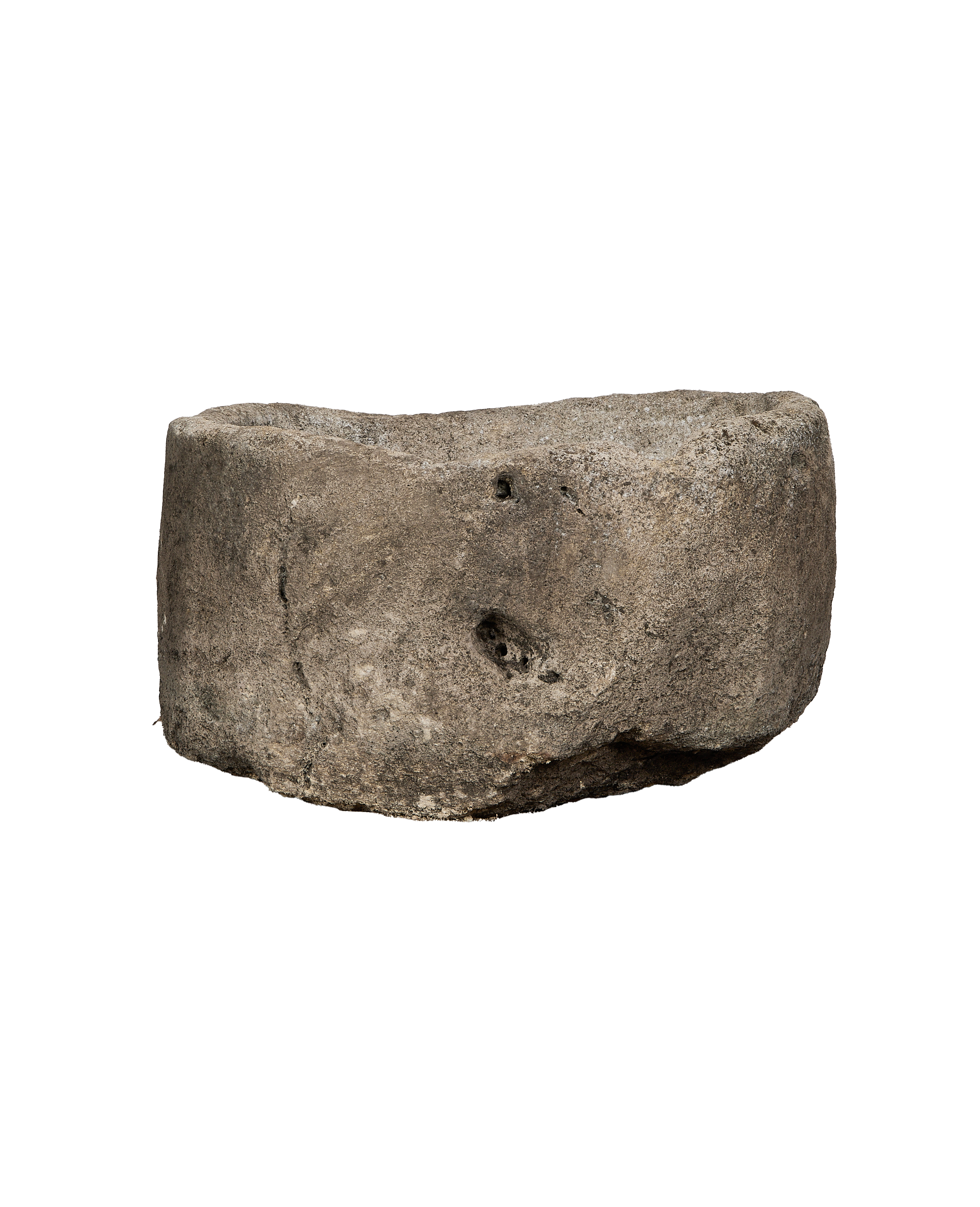 Vintage Indonesian oblong limestone trough, showing a side view with rugged texture and natural cavities.