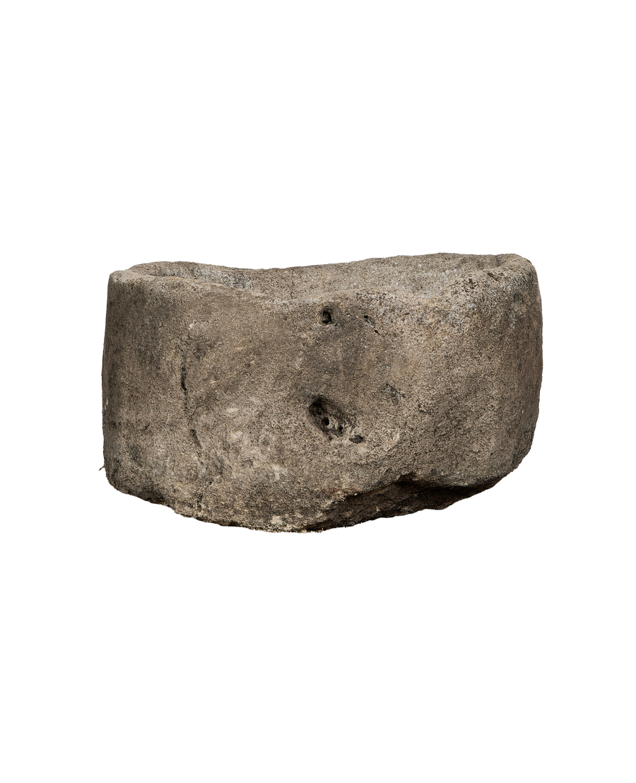 Vintage Indonesian oblong limestone trough, showing a side view with rugged texture and natural cavities.