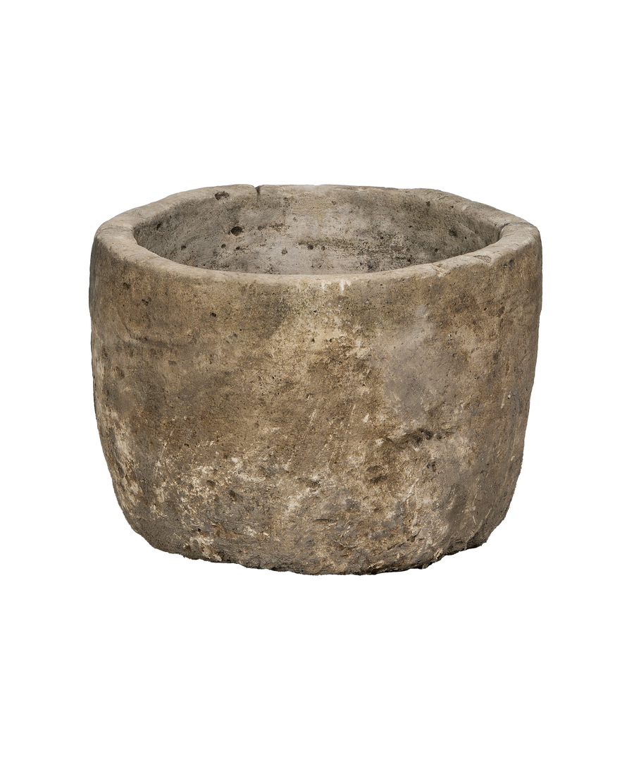 Vintage round limestone trough, Indonesia, showing textured exterior and aged patina from a mid-angle view.