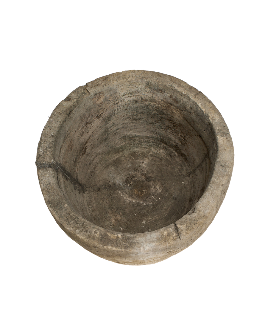 Vintage Indonesian round limestone trough, rich interior texture, weathered, full overhead view.