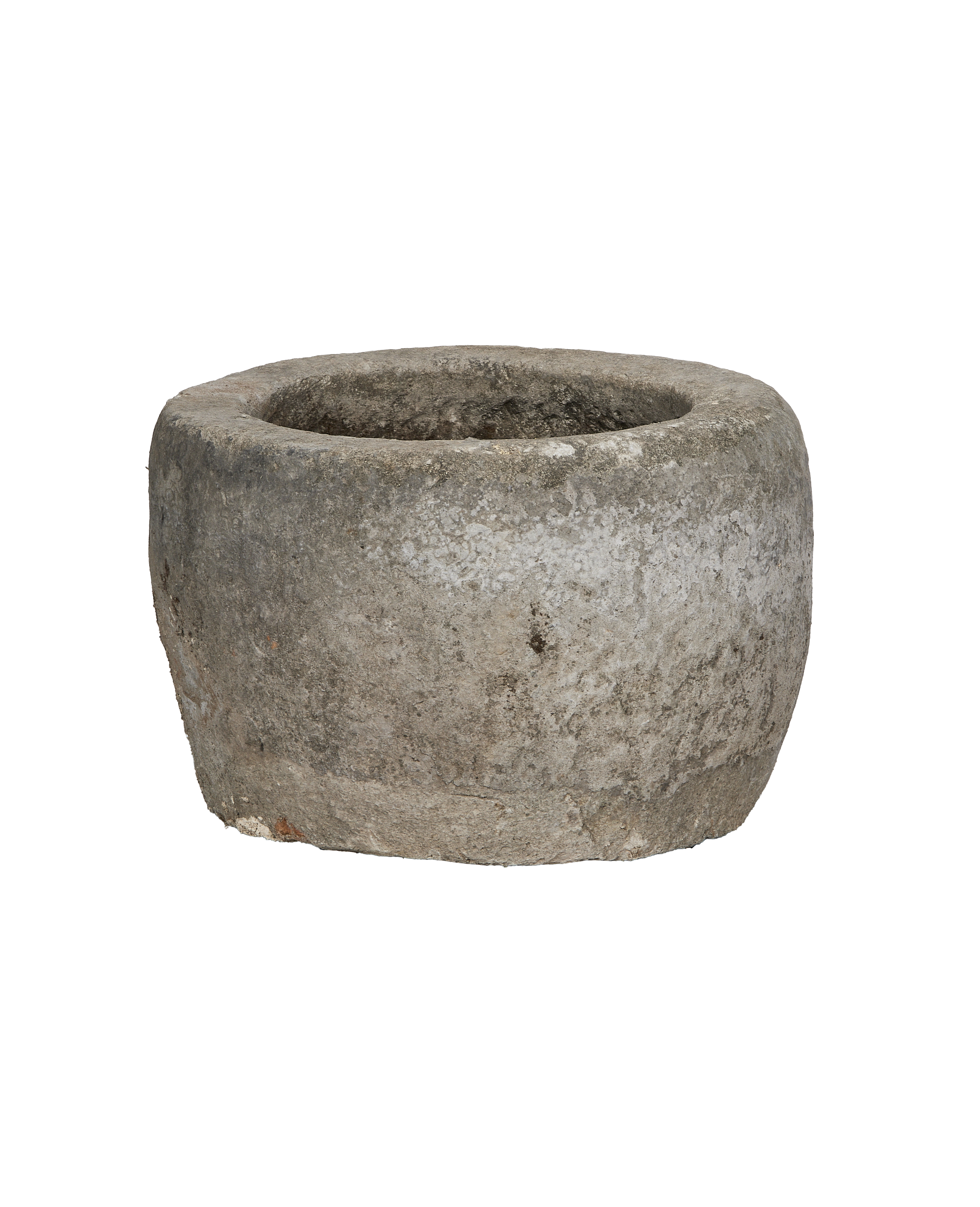 Vintage Indonesian round limestone trough, showing weathered texture and interior basin detail from side.