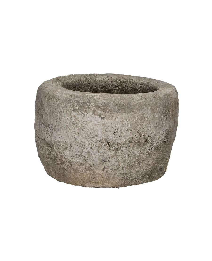 Vintage Indonesian limestone trough, round, showing distressed external texture and unique patina.