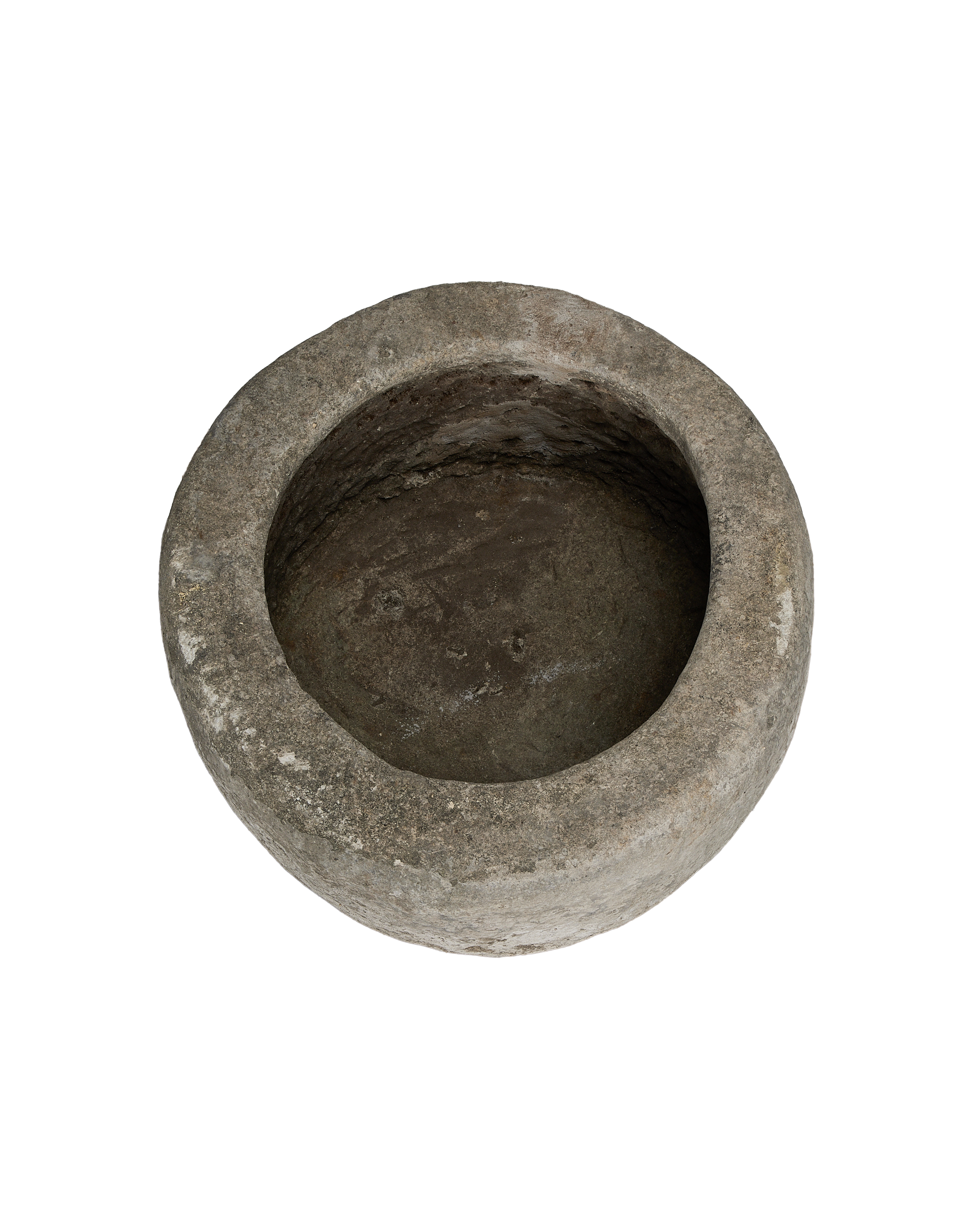 Vintage round limestone trough, top view showing aged interior texture and rough rim.