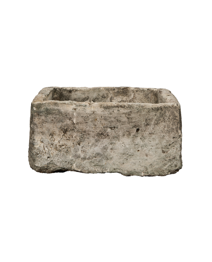 Vintage rectangular limestone trough, showing aged texture, weathered cracks, and uneven edges.