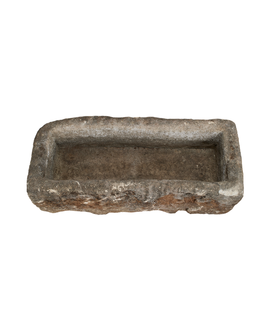 Vintage Indonesian limestone rectangular trough, weathered exterior with rough texture and white remnants inside.