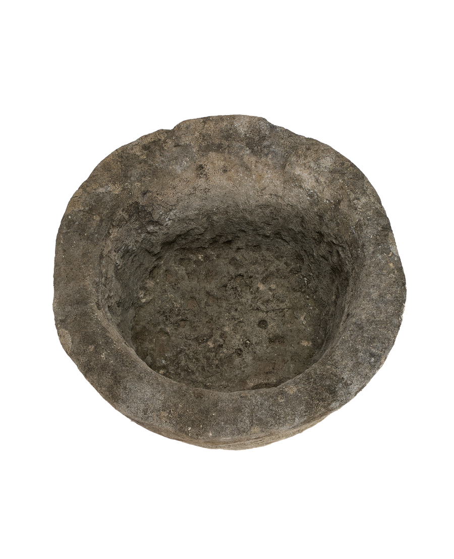 Vintage Indonesian limestone trough, top-down view highlighting the rough, weathered interior texture.
