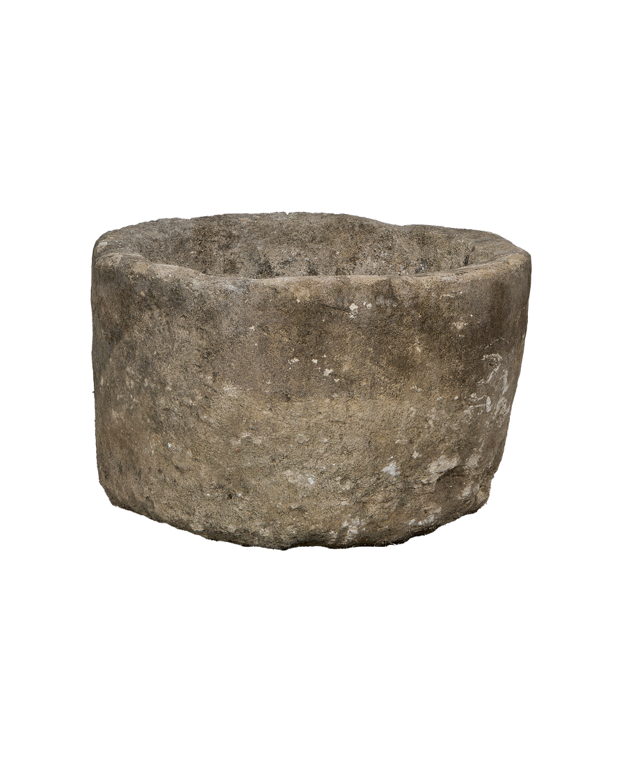 Vintage Indonesian round limestone trough, showing its aged, rugged exterior surface and texture.