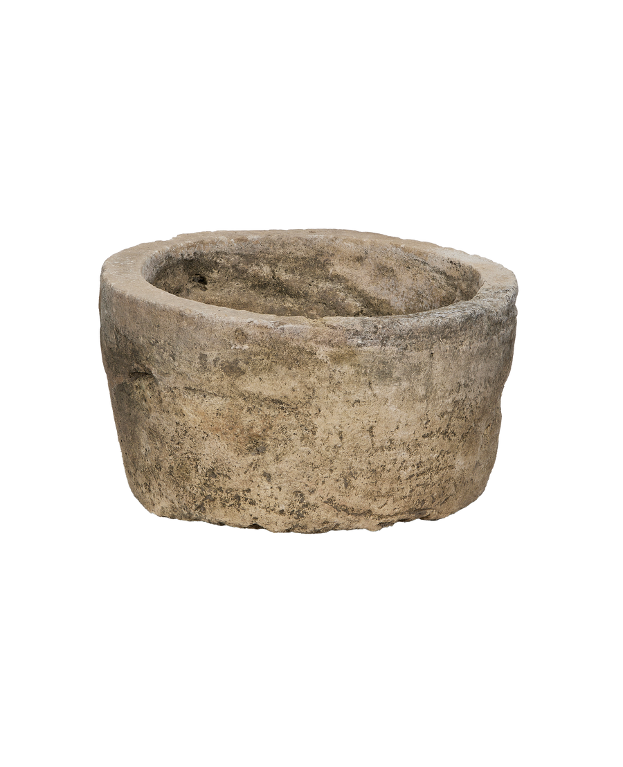 Vintage limestone trough, round, showcasing natural rough texture and weathered finish.