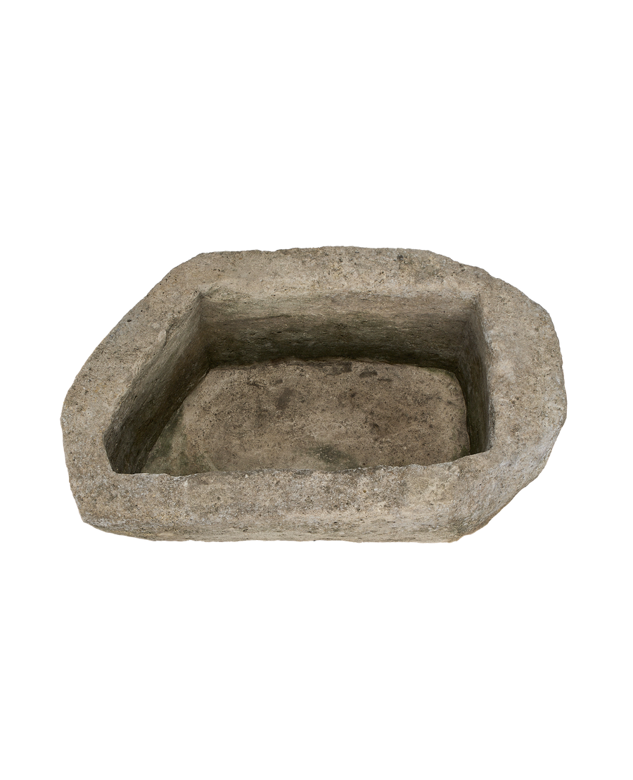 Oblong vintage limestone trough (Indonesia) showing rough, weathered interior basin texture.